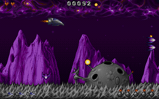 Side-scrolling shooter gameplay with spaceship firing at enemies