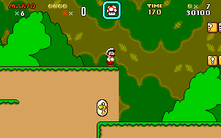 Mario standing on a green platform in Super Mario World DX